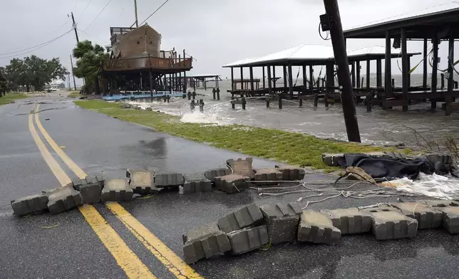 A block wall, knocked over from storm surge, blocks a road near homes in Horseshoe Beach, Fla., Monday, Aug. 5, 2024. Hurricane Debby made landfall early this morning. (AP Photo/Christopher O'Meara)