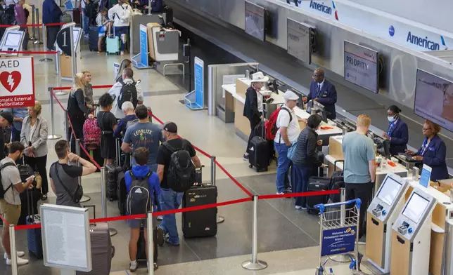 Passengers wait in line at American Airlines in Terminal B at the Philadelphia International Airport, Monday morning, Aug. 5, 2024, as they deal with cancelled flights to the south due to Hurricane Debby. (Alejandro A. Alvarez/The Philadelphia Inquirer via AP)