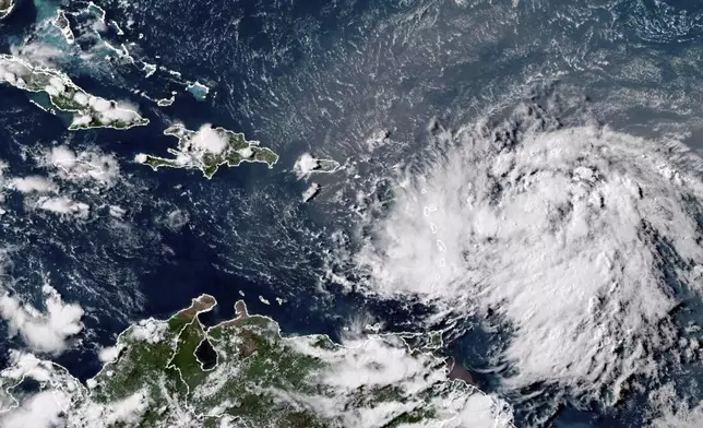 This GOES-16 GeoColor satellite image taken at 4:30 p.m. EDT and provided by National Oceanic and Atmospheric Administration (NOAA) shows Tropical Storm Ernesto over the Atlantic Ocean and moving west-northwest toward the Lesser Antilles, Monday, Aug. 12, 2024. (NOAA via AP)