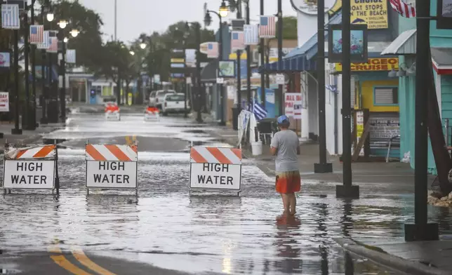 Flood water blocks a section of Dodecanese Blvd at the Tarpon Springs Sponge Docks, Monday morning, Aug 5, 2024, in Tarpon Springs, Fla., as Hurricane Debby passes the Tampa Bay area offshore. (Douglas R. Clifford/Tampa Bay Times via AP)