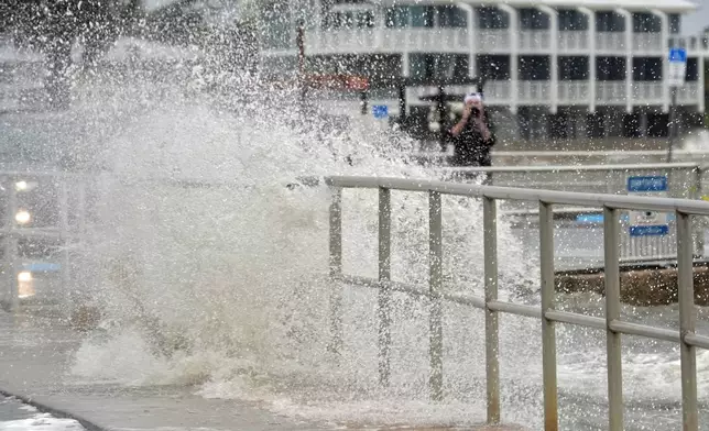 The surf pushed by winds from Tropical Storm Debby break over the sea wall in Cedar Key, Fla., on Sunday, Aug. 4, 2024. (AP Photo/Christopher O'Meara)