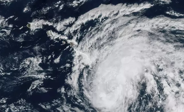 This image provided by the National Oceanic and Atmospheric Administration shows Tropical Storm Hone as it continues to track to the west toward the Hawaiian Islands, Saturday, Aug. 24, 2024. (National Oceanic and Atmospheric Administration via AP)