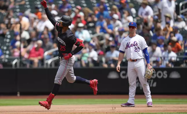 New York Mets first baseman Pete Alonso watches, right, watches as Minnesota Twins' Byron Buxton celebrates after hitting a solo home run during the second inning of a baseball game at Citi Field, Wednesday, July 31, 2024, in New York. (AP Photo/Seth Wenig)