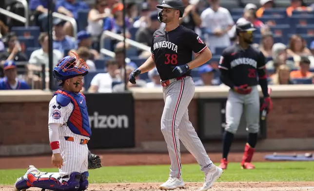 New York Mets catcher Francisco Alvarez, left, reacts as Minnesota Twins' Matt Wallner crosses home plate after hitting a two-run home run during the third inning of a baseball game at Citi Field, Wednesday, July 31, 2024, in New York. (AP Photo/Seth Wenig)