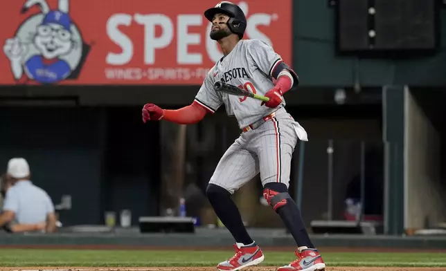 Minnesota Twins' Willi Castro watches his solo home run that came off a pitch from Texas Rangers' Cody Bradford in the second inning of a baseball game, Thursday, Aug. 15, 2024, in Arlington, Texas. (AP Photo/Tony Gutierrez)