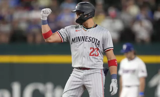 Minnesota Twins' Royce Lewis celebrates his double against the Texas Rangers in the first inning of a baseball game, Thursday, Aug. 15, 2024, in Arlington, Texas. (AP Photo/Tony Gutierrez)