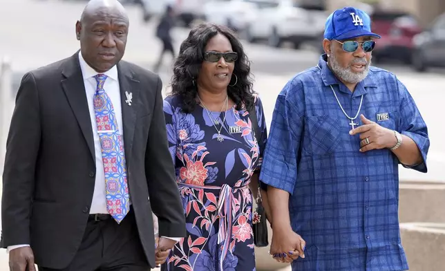 RowVaughn Wells, center and husband Rodney Wells, right, parents of Tyre Nichols walk into federal court with their attorney Ben Crump, left, to attend a plea hearing for one of the former Memphis Police Department officers accused of killing their son.Friday, Aug. 23, 2024, in Memphis, Tenn. (AP Photo/George Walker IV)