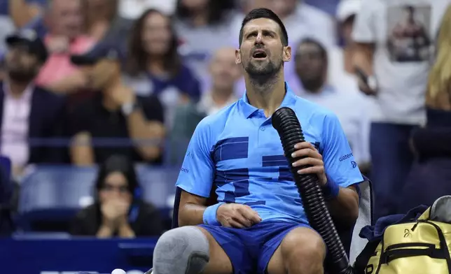 Novak Djokovic, of Serbia, tries to stay cool during a third round match against Alexei Popyrin, of Australia, of the U.S. Open tennis championships, Friday, Aug. 30, 2024, in New York. (AP Photo/Julia Nikhinson)