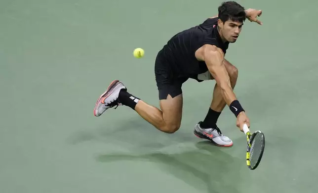 Carlos Alcaraz, of Spain returns a shot to Botic van De Zandschulp, of the Netherlands, during the second round of the U.S. Open tennis championships, Thursday, Aug. 29, 2024, in New York. (AP Photo/Matt Rourke)