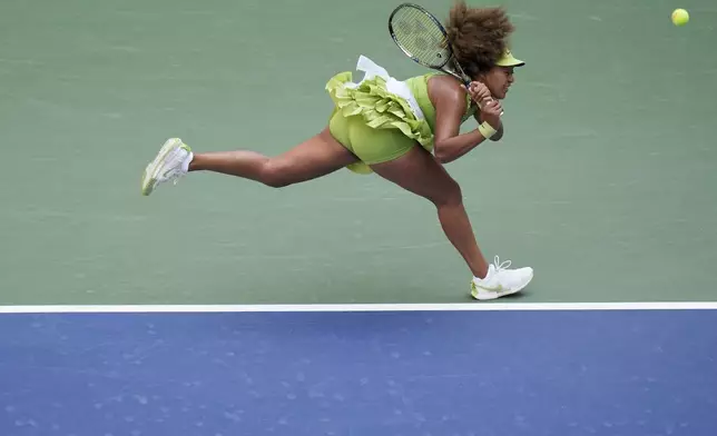 Naomi Osaka, of Japan, returns a shot to Jelena Ostapenko, of Latvia, during the first round of the U.S. Open tennis championships, Tuesday, Aug. 27, 2024, in New York. (AP Photo/Seth Wenig)