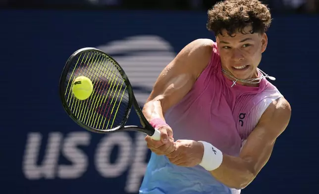 Ben Shelton, of the United States, returns a shot to Dominic Thiem, of Austria, during the first round of the U.S. Open tennis championships, Monday, Aug. 26, 2024, in New York. (AP Photo/Seth Wenig)