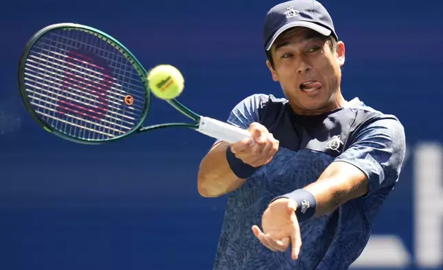 Mackenzie McDonald, of the United States, returns a shot to Jannik Sinner, of Italy, during the first round of the U.S. Open tennis championships, Tuesday, Aug. 27, 2024, in New York. (AP Photo/Kirsty Wigglesworth)