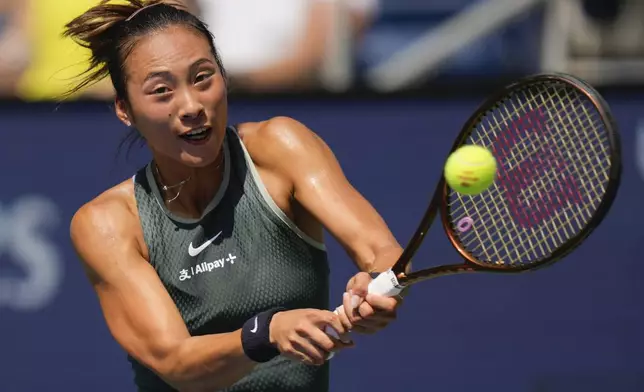 Zheng Qinwen, of China, returns a shot to Amanda Anisimova, of the United States, during the first round of the U.S. Open tennis championships, Monday, Aug. 26, 2024, in New York. (AP Photo/Kirsty Wigglesworth)