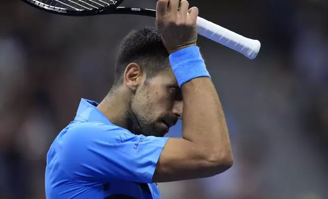 Novak Djokovic, of Serbia, wipes his face against =Alexei Popyrin, of Australia, during a third round match of the U.S. Open tennis championships, Friday, Aug. 30, 2024, in New York. (AP Photo/Julia Nikhinson)