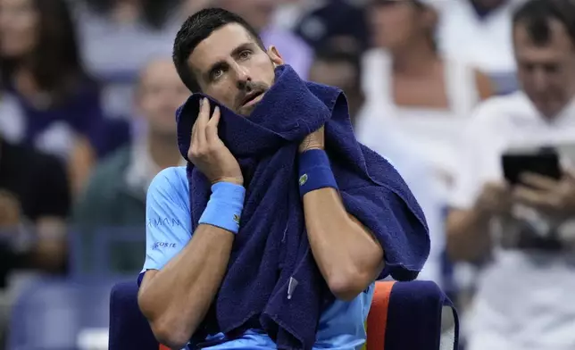 Novak Djokovic, of Serbia, wipes his face during a third round match against Alexei Popyrin, of Australia, of the U.S. Open tennis championships, Friday, Aug. 30, 2024, in New York. (AP Photo/Julia Nikhinson)