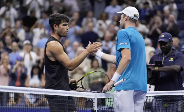 Botic van De Zandschulp, right, of the Netherlands, greets Carlos Alcaraz, of Spain, during the second round of the U.S. Open tennis championships, Thursday, Aug. 29, 2024, in New York. (AP Photo/Matt Rourke)