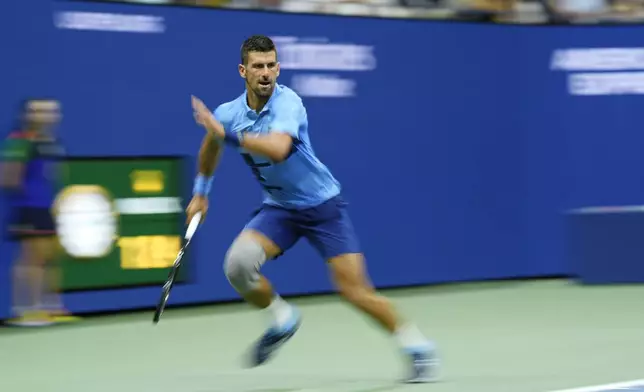 Novak Djokovic, of Serbia, returns a shot to Radu Albot, of Moldova, during a first round match of the U.S. Open tennis championships, Monday, Aug. 26, 2024, in New York. (AP Photo/Matt Rourke)