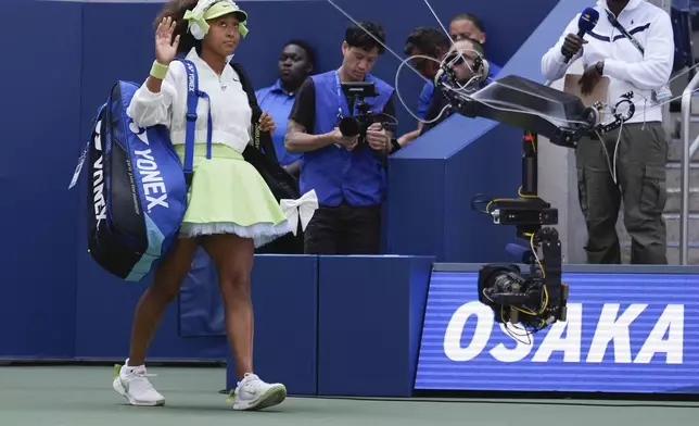 Naomi Osaka, of Japan, walks on the court before playing against Jelena Ostapenko, of Latvia, during the first round of the U.S. Open tennis championships, Tuesday, Aug. 27, 2024, in New York. (AP Photo/Seth Wenig)