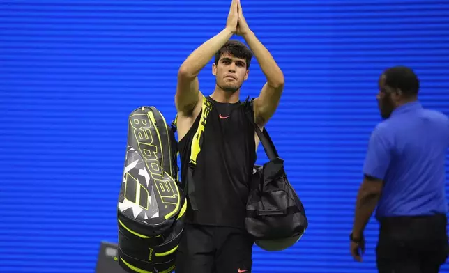 Carlos Alcaraz, of Spain, gestures to fans after losing to Botic van De Zandschulp, of the Netherlands, in a second round match of the U.S. Open tennis championships, Thursday, Aug. 29, 2024, in New York. (AP Photo/Frank Franklin II)