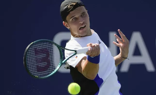 Jakub Mensik, of the Czech Republic, returns a shot to Felix Auger-Aliassime, of Canada, during the first round of the U.S. Open tennis championships, Tuesday, Aug. 27, 2024, in New York. (AP Photo/Pamela Smith)