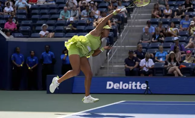 Naomi Osaka, of Japan, serves to Jelena Ostapenko, of Latvia, during the first round of the U.S. Open tennis championships, Tuesday, Aug. 27, 2024, in New York. (AP Photo/Seth Wenig)