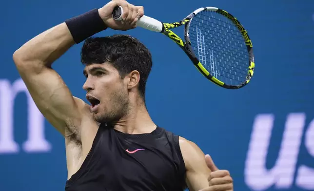 Carlos Alcaraz, of Spain returns a shot to Botic van De Zandschulp, of the Netherlands, during the second round of the U.S. Open tennis championships, Thursday, Aug. 29, 2024, in New York. (AP Photo/Matt Rourke)