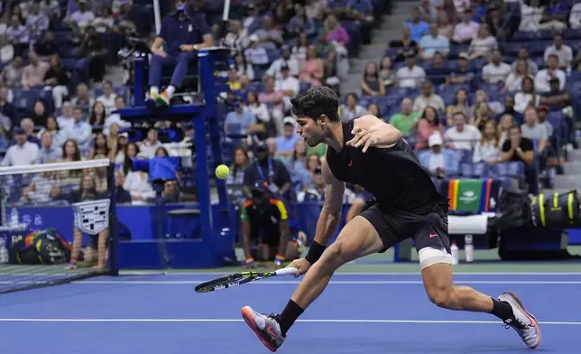 Carlos Alcaraz, of Spain returns a shot to Botic van De Zandschulp, of the Netherlands, during the second round of the U.S. Open tennis championships, Thursday, Aug. 29, 2024, in New York. (AP Photo/Matt Rourke)