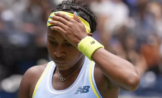 Coco Gauff, of the United States, adjusts her head band during a match against Elina Svitolina, of Ukraine, during the third round of the U.S. Open tennis championships, Friday, Aug. 30, 2024, in New York. (AP Photo/Seth Wenig)