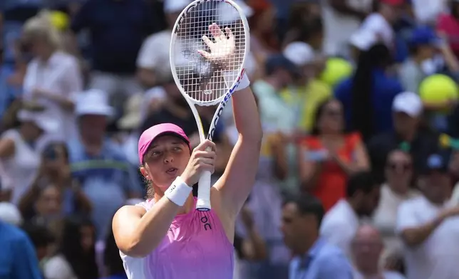 Iga Swiatek, of Poland, waves to fans after defeating Kamilla Rakhimova, during the first round of the U.S. Open tennis championships, Tuesday, Aug. 27, 2024, in New York. (AP Photo/Kirsty Wigglesworth)