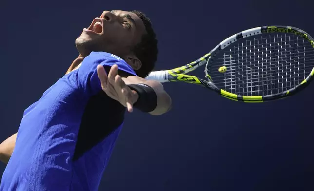 Felix Auger-Aliassime, of Canada, returns a shot to Jakub Mensik, of the Czech Republic, during the first round of the U.S. Open tennis championships, Tuesday, Aug. 27, 2024, in New York. (AP Photo/Pamela Smith)