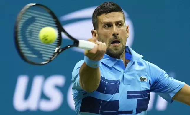 Novak Djokovic, of Serbia, returns a shot to Radu Albot, of Moldova, during a first round match of the U.S. Open tennis championships, Monday, Aug. 26, 2024, in New York. (AP Photo/Matt Rourke)