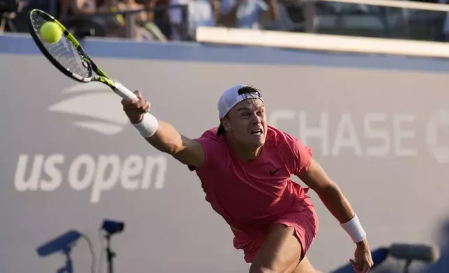 Brandon Nakashima, of the United States, returns a shot to Holger Rune, of Denmark, during a first round match of the U.S. Open tennis championships, Monday, Aug. 26, 2024, in New York. (AP Photo/Matt Rourke)