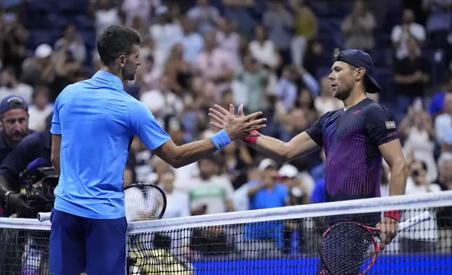 Novak Djokovic, of Serbia, greets Radu Albot, of Moldova, after winning their first round match of the U.S. Open tennis championships, Monday, Aug. 26, 2024, in New York. (AP Photo/Matt Rourke)