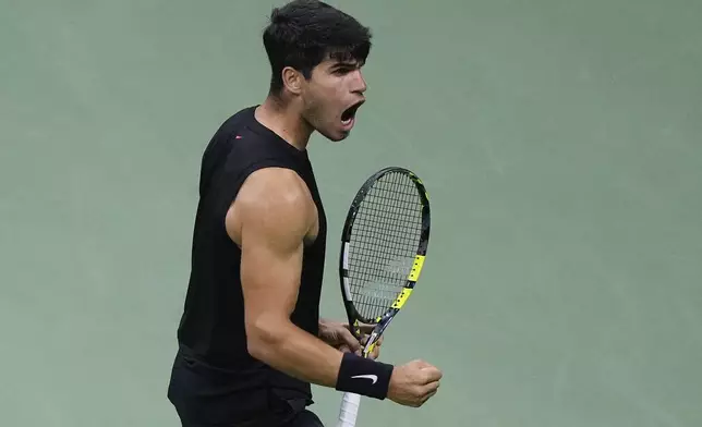 Carlos Alcaraz, of Spain, reacts after scoring a point against Botic van De Zandschulp, of the Netherlands, during the second round of the U.S. Open tennis championships, Thursday, Aug. 29, 2024, in New York. (AP Photo/Matt Rourke)