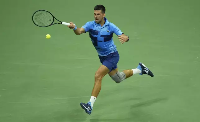 Novak Djokovic, of Serbia, returns a shot to Radu Albot, of Moldova, during a first round match of the U.S. Open tennis championships, Monday, Aug. 26, 2024, in New York. (AP Photo/Matt Rourke)