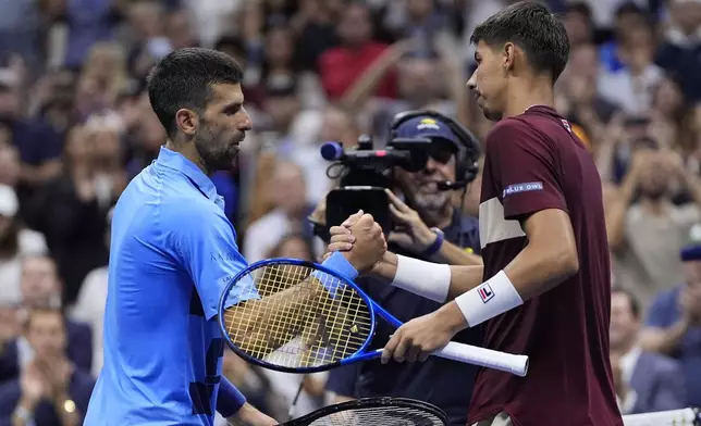 Novak Djokovic, of Serbia, shakes hands with Alexei Popyrin, of Australia, during a third round match of the U.S. Open tennis championships, Friday, Aug. 30, 2024, in New York. (AP Photo/Julia Nikhinson)