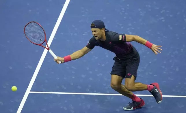 Radu Albot, of Moldova, returns a shot to Novak Djokovic, of Serbia, during a first round match of the U.S. Open tennis championships, Monday, Aug. 26, 2024, in New York. (AP Photo/Matt Rourke)