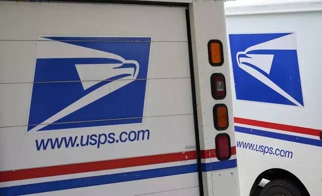 FILE - U.S. Postal Service delivery vehicles are parked outside a post office in Boys Town, Neb., Aug. 18, 2020. (AP Photo/Nati Harnik, File)