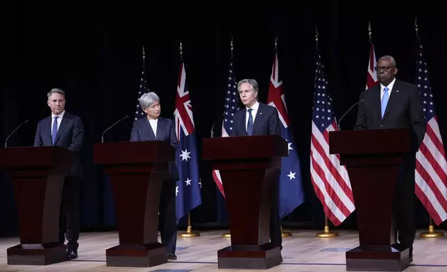 Secretary of State Antony Blinken, second from right, standing with, from left, Australia's Deputy Prime Minister and Defense Minister Richard Marles, Australia's Foreign Minister Penny Wong, and Defense Secretary Lloyd Austin, speaks during a news conference at the United States Naval Academy in Annapolis, Md., Tuesday, Aug. 6, 2024. (AP Photo/Susan Walsh)