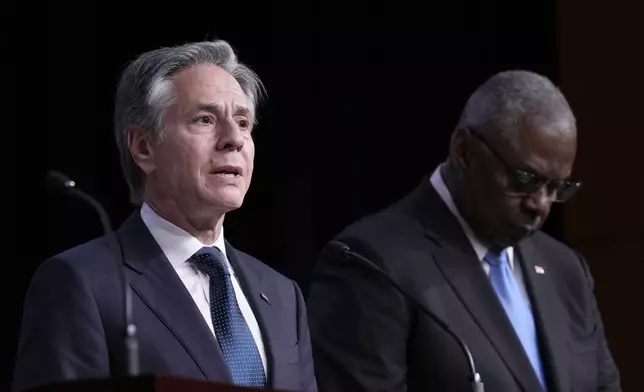 Secretary of State Antony Blinken, left, standing with Defense Secretary Lloyd Austin, right, speaks during a news conference at the United States Naval Academy in Annapolis, Md., Tuesday, Aug. 6, 2024. (AP Photo/Susan Walsh)