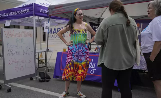 Illinois Rep. Kelly Cassidy talks with visitors to the Glenwood Avenue Arts Festival about canvassing efforts for the Democratic Party, Monday, Aug. 26, 2024, in Chicago. (AP Photo/Erin Hooley)