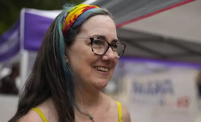 Illinois Rep. Kelly Cassidy talks with visitors to the Glenwood Avenue Arts Festival about canvassing efforts for the Democratic Party, Monday, Aug. 26, 2024, in Chicago. (AP Photo/Erin Hooley)