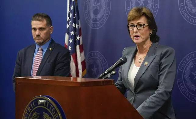 Harris County District Attorney Kim Ogg announces corruption charges related to 2022 Election alongside Michael Levine, Chief Assistant District Attorney for Public Corruption, during a press conference Tuesday, Aug. 13, 2024, in Houston. Prosecutors say an investigation found no evidence of intent to influence 2022 election outcomes, but Ogg said that her office will pursue criminal charges against a county employee who was allegedly working a second job while polls ran out of paper ballots. (Raquel Natalicchio/Houston Chronicle via AP)