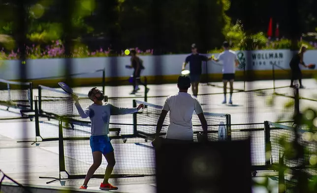 People practice pickleball on the courts of CityPickle at Central Park's Wollman Rink, Saturday, Aug. 24, 2024, in New York. (AP Photo/Eduardo Munoz Alvarez)