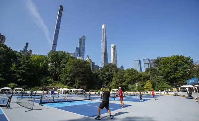 People practice pickleball on the courts of CityPickle at Central Park's Wollman Rink, Saturday, Aug. 24, 2024, in New York. (AP Photo/Eduardo Munoz Alvarez)