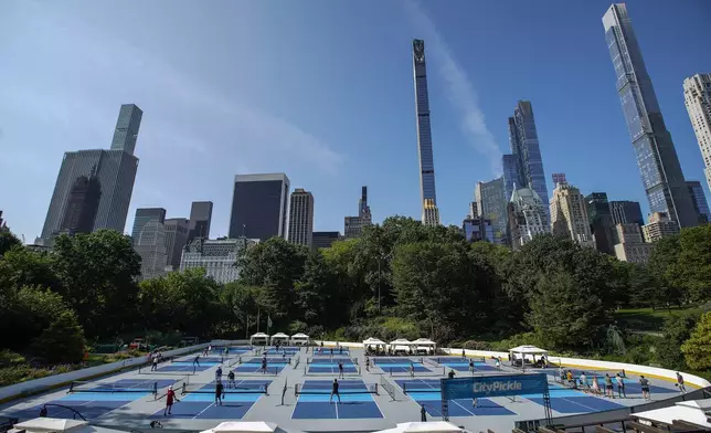 People practice pickleball on the courts of CityPickle at Central Park's Wollman Rink, Saturday, Aug. 24, 2024, in New York. (AP Photo/Eduardo Munoz Alvarez)