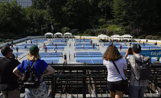 People practice pickleball on the courts of CityPickle at Central Park's Wollman Rink, Saturday, Aug. 24, 2024, in New York. (AP Photo/Eduardo Munoz Alvarez)