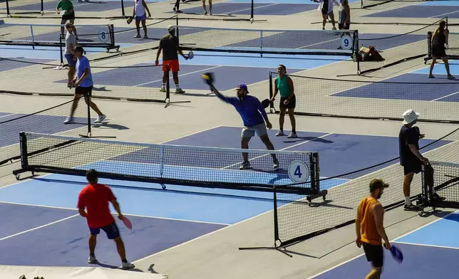 People practice pickleball on the courts of CityPickle at Central Park's Wollman Rink, Saturday, Aug. 24, 2024, in New York. (AP Photo/Eduardo Munoz Alvarez)