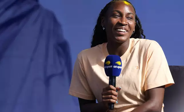 Coco Gauff smiles while speaking to the crowd at the US Open Fan Week at the USTA Billie Jean King National Tennis Center in New York, Tuesday, Aug. 20, 2024. (AP Photo/Pamela Smith)