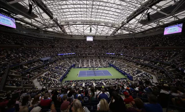 FILE - With rain falling outside, Naomi Osaka, of Japan, and Belinda Bencic, of Switzerland, play their match under the roof of Arthur Ashe Stadium during the fourth round of the U.S. Open tennis championships, Monday, Sept. 2, 2019, in New York. (AP Photo/Frank Franklin II, File)